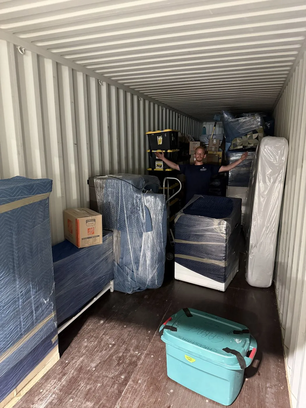 Furniture wrapped in moving blankets and shrink wrap, loaded and secured by Pearl Movers