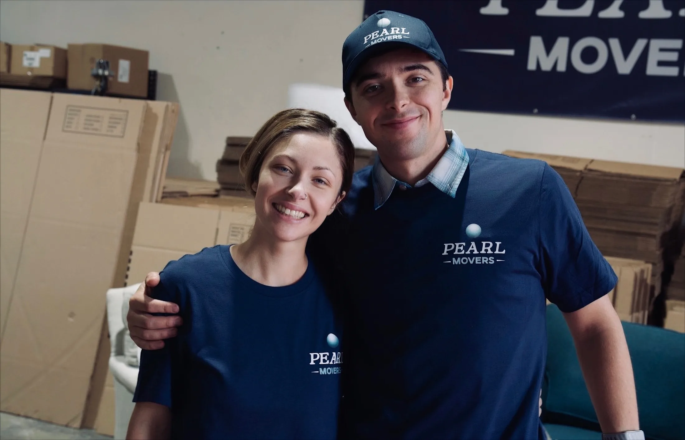 Two Pearl Movers crew members in branded shirts at the Portland warehouse