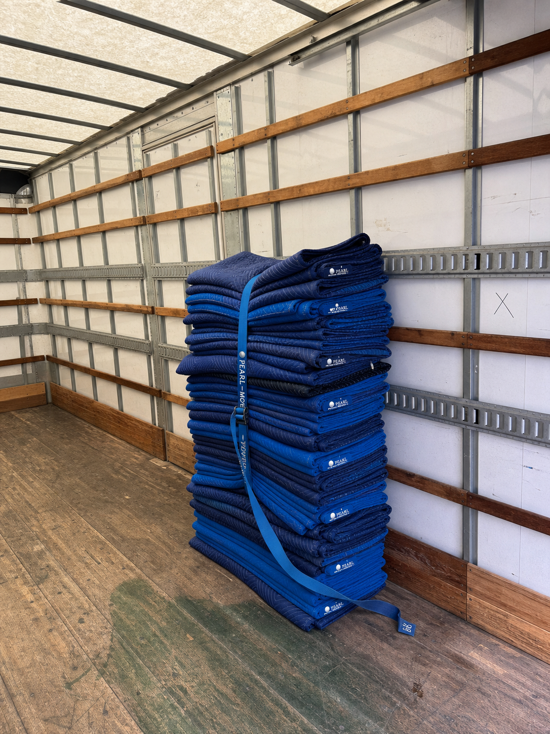 Pearl Movers moving blankets stacked inside a truck